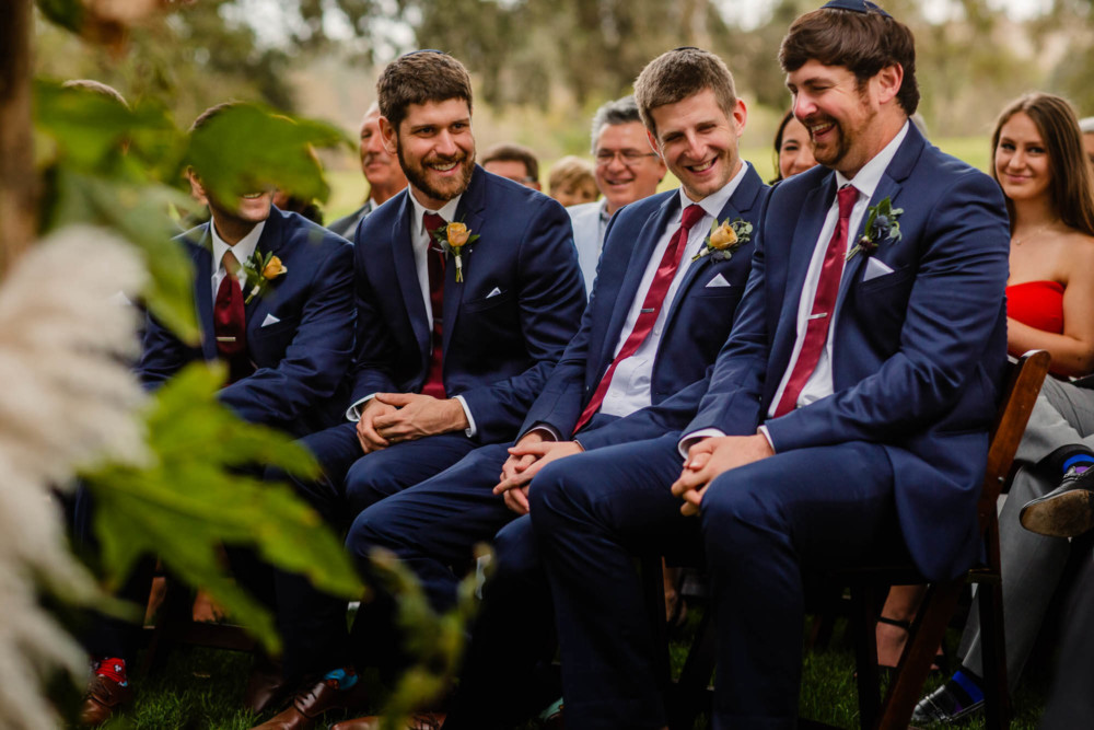 Groomsmen share a laugh during the wedding ceremony
