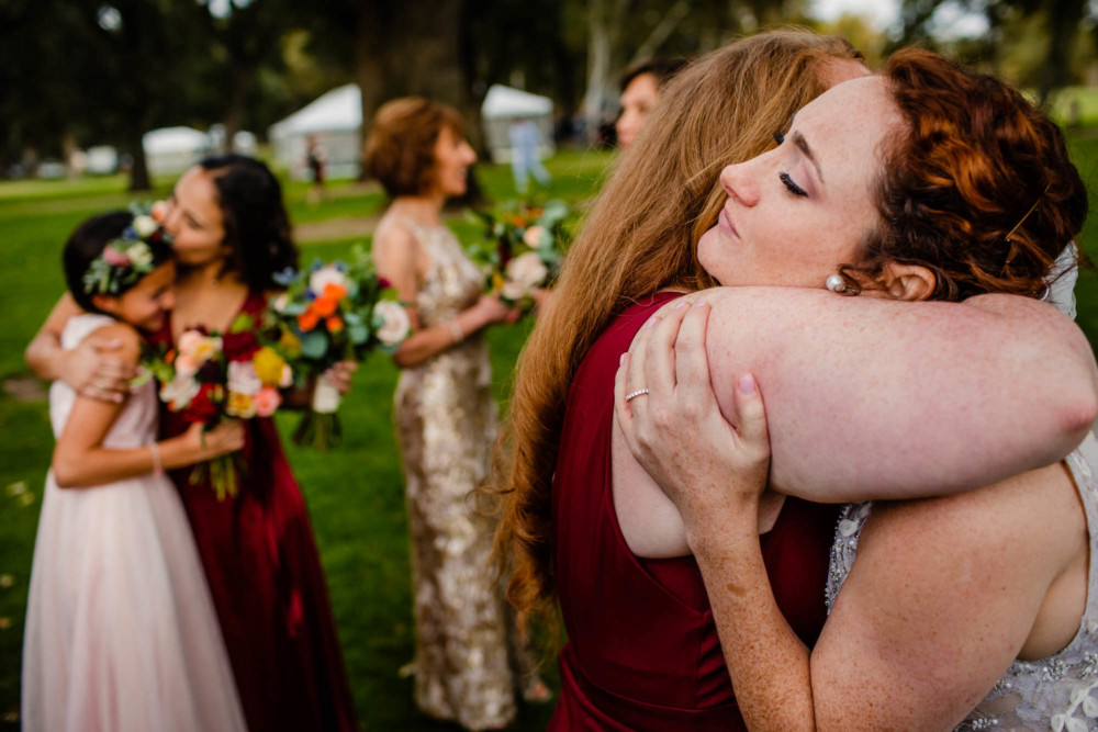 Post ceremony hugs between bride, bridesmaids and flower girl