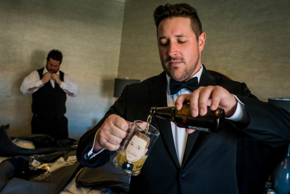 Groom pouring a beer into a custom caricature mug
