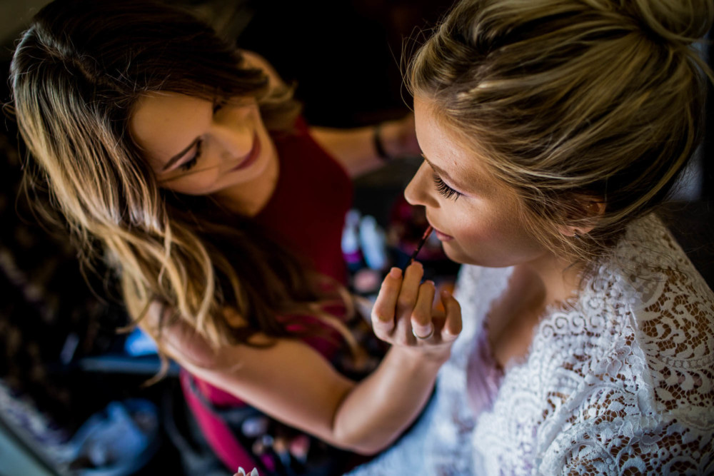 Bride having her makeup done by a make up artist