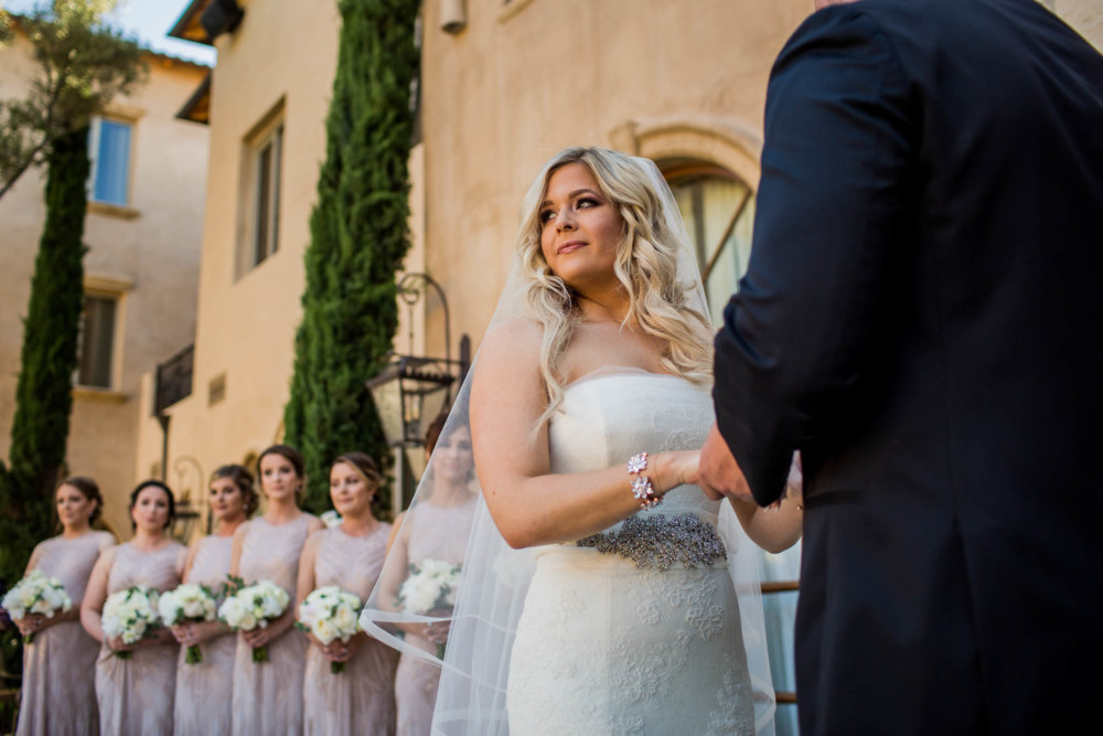 Bride looks out to the guests with tears in her eyes during the wedding ceremony