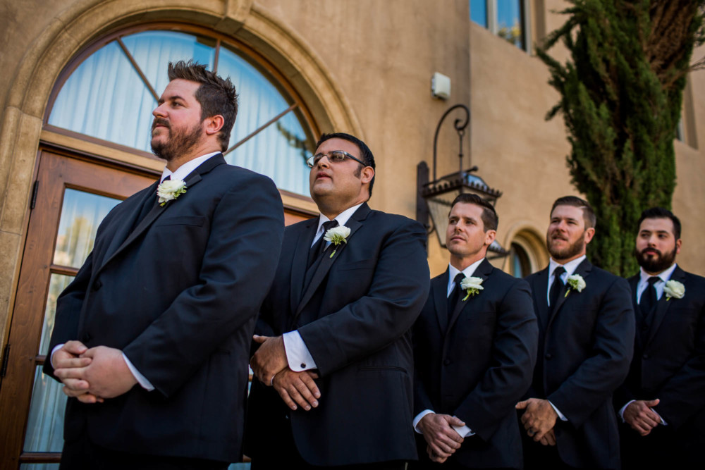 Groomsmen look on during the ceremony