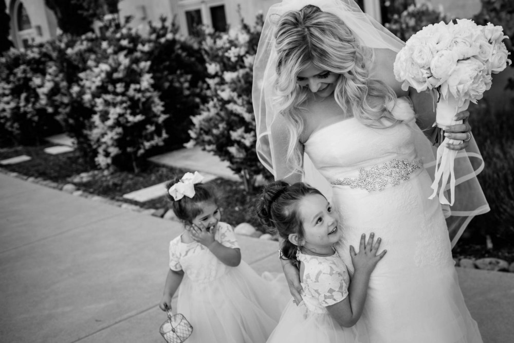 Bride gets a hug from a flower girl
