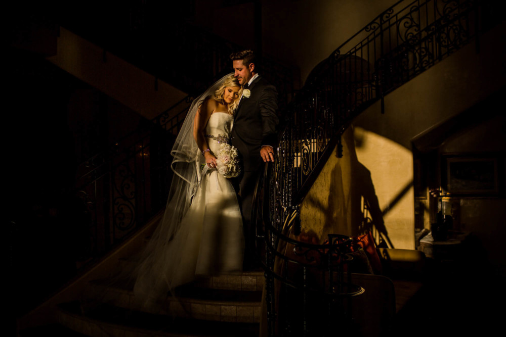 Portrait of the bride and groom on the stairs in the evening light at the Allegretto Vineyard Resort in Paso Robles, CA