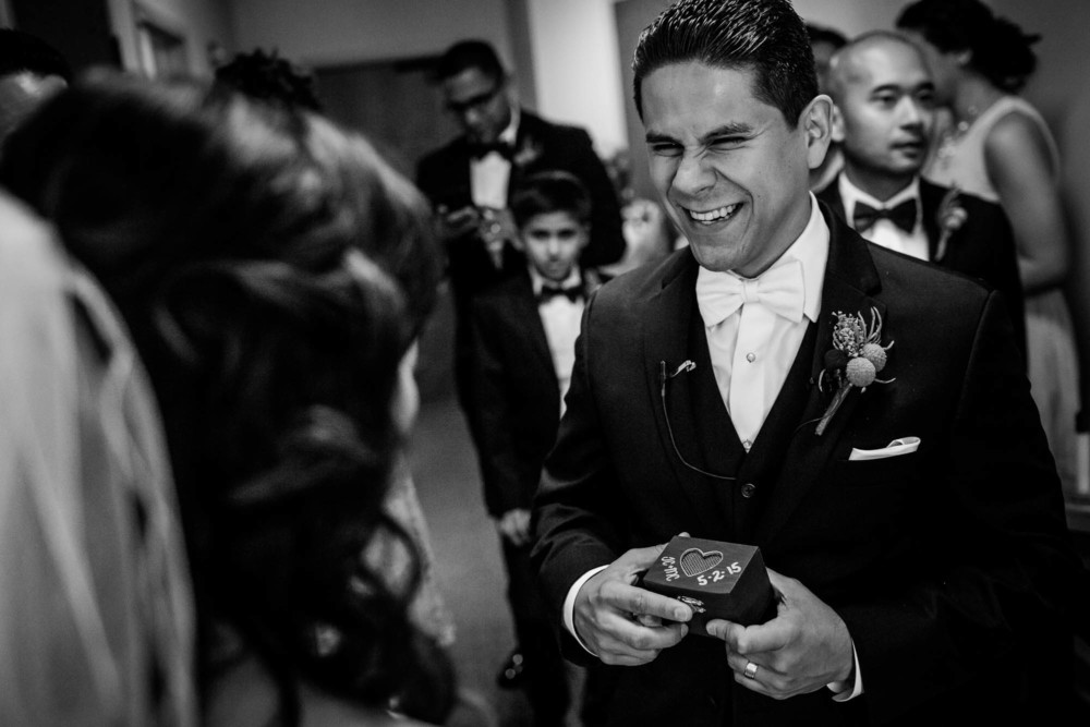 Groom shows off the custom ring box after their wedding ceremony