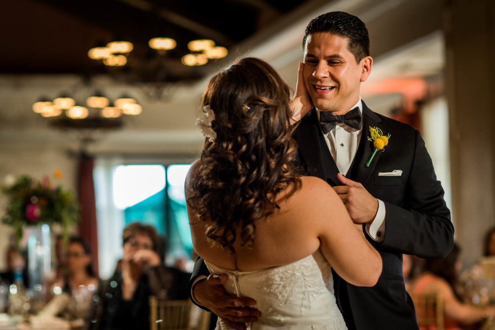 Groom looks into bride's eyes during their first dance
