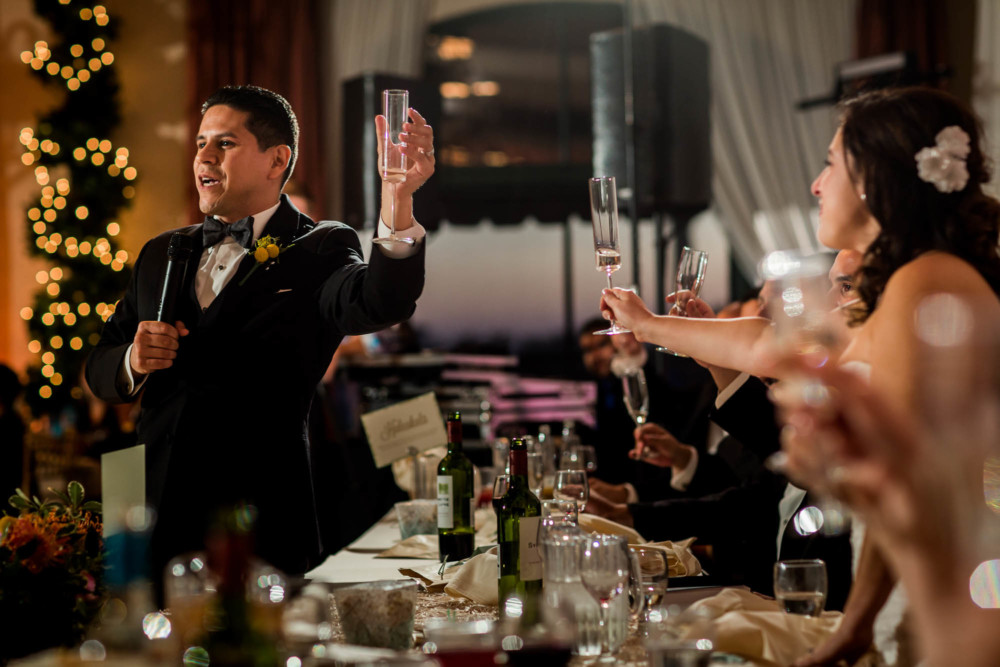 Groom raises a glass during his wedding speach