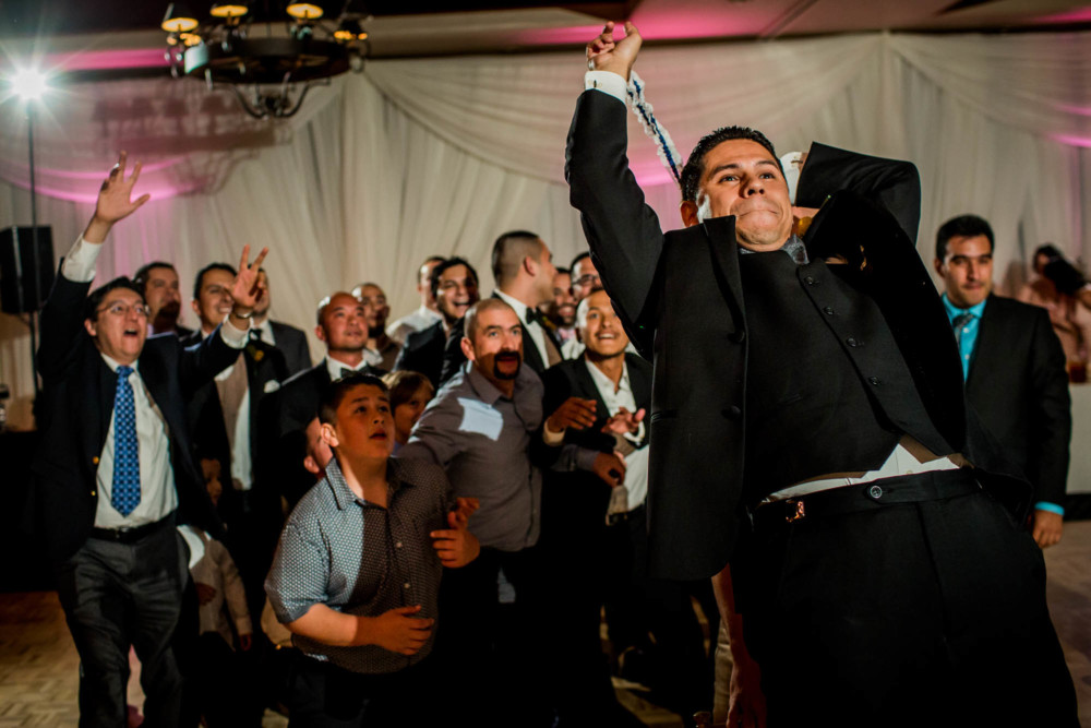 Groom throws the garter during the wedding reception