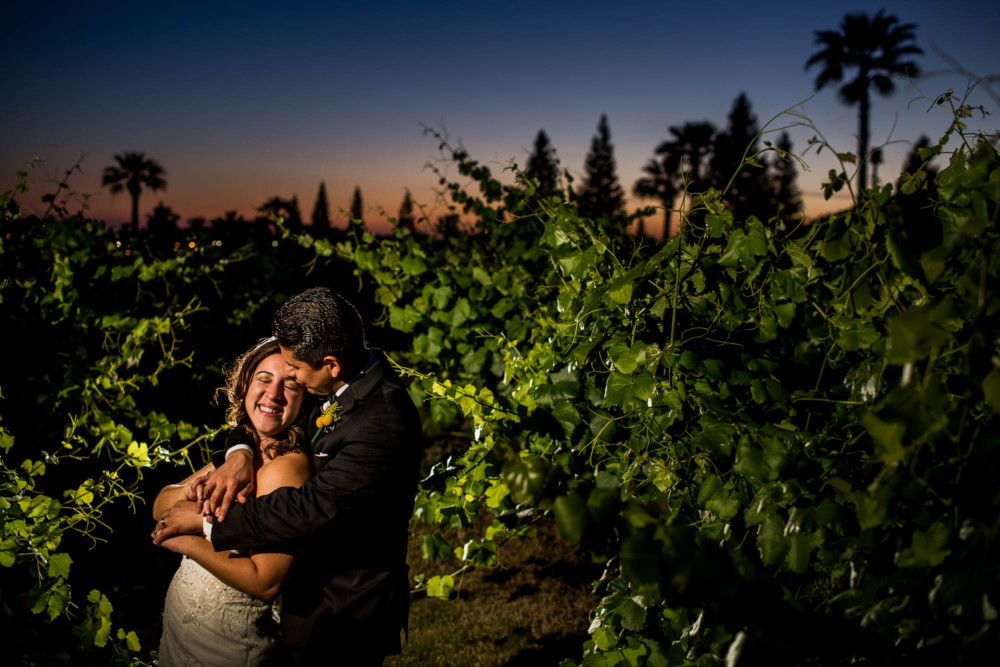 tender portrait of bride and groom in the vineyard at sunset at Copper River Country Club