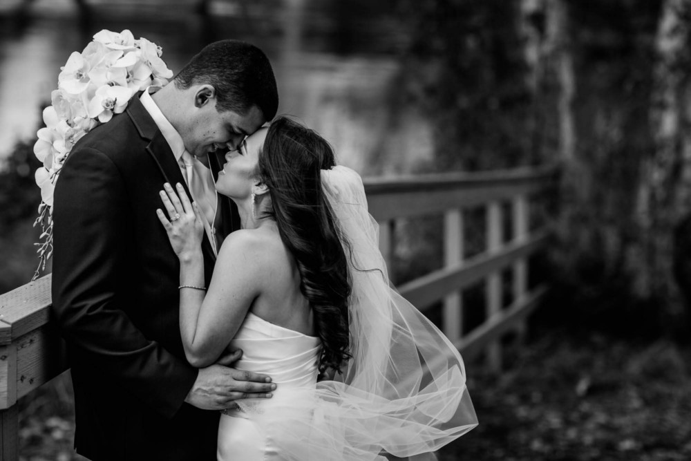 black and white portrait of the bride and groom sharing a tender moment