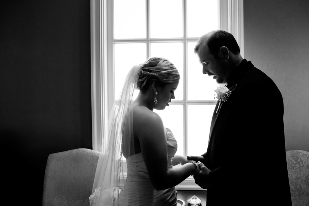 bride and groom sharing a private prayer after their wedding