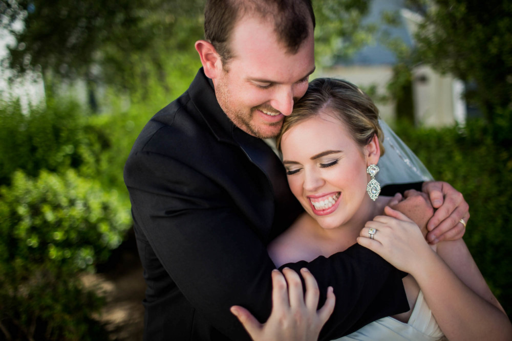 portrait of a bride and groom hugging
