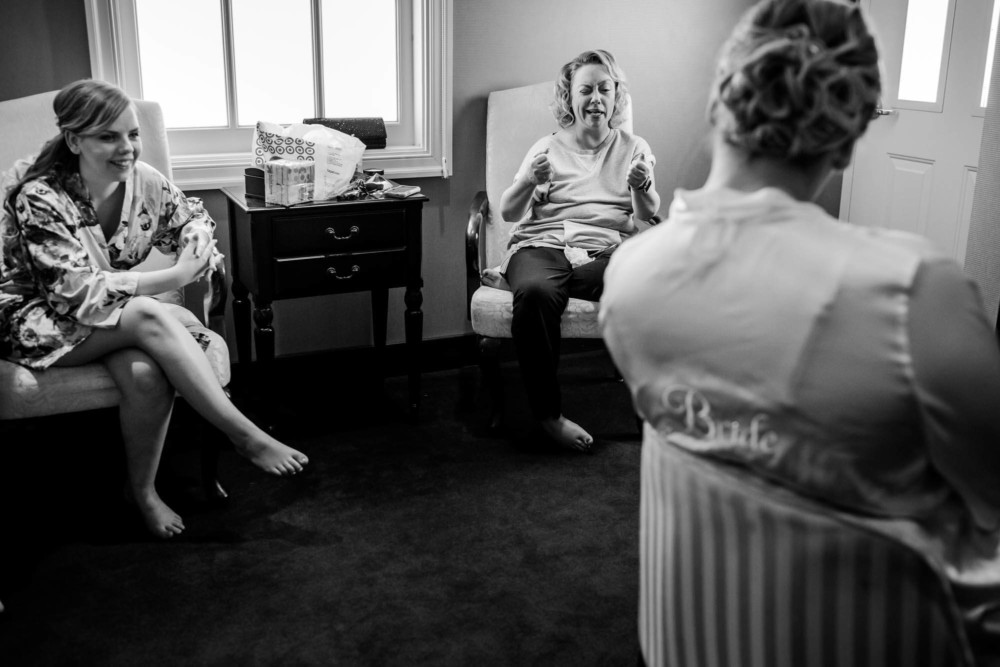 Sister and mother share a laugh with the bride