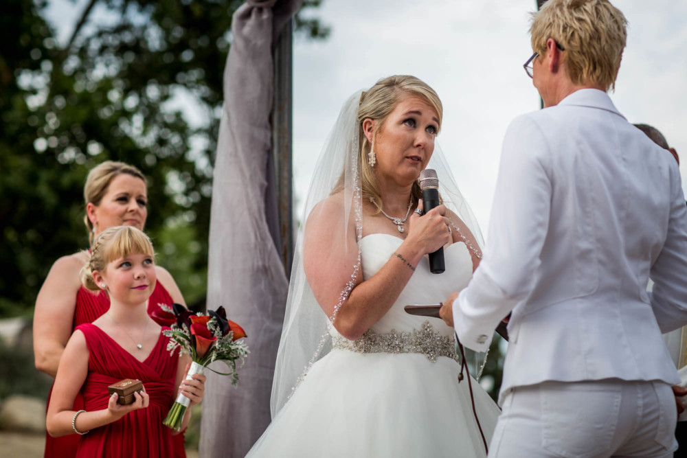 Bride saying her vows as her daughter looks on