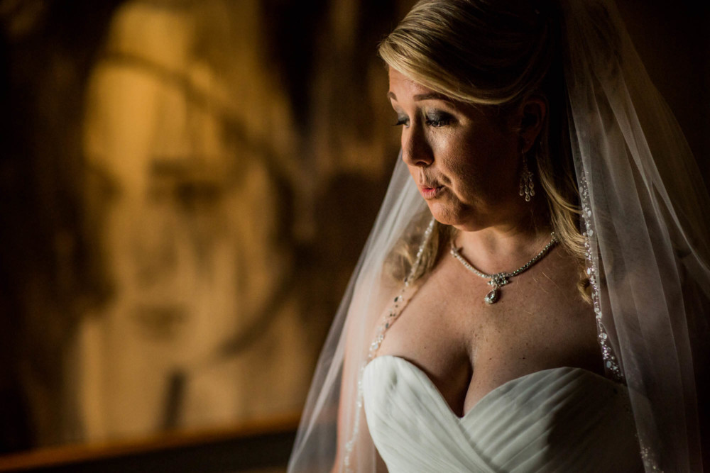 Bride lets out a sigh after finishing dressing