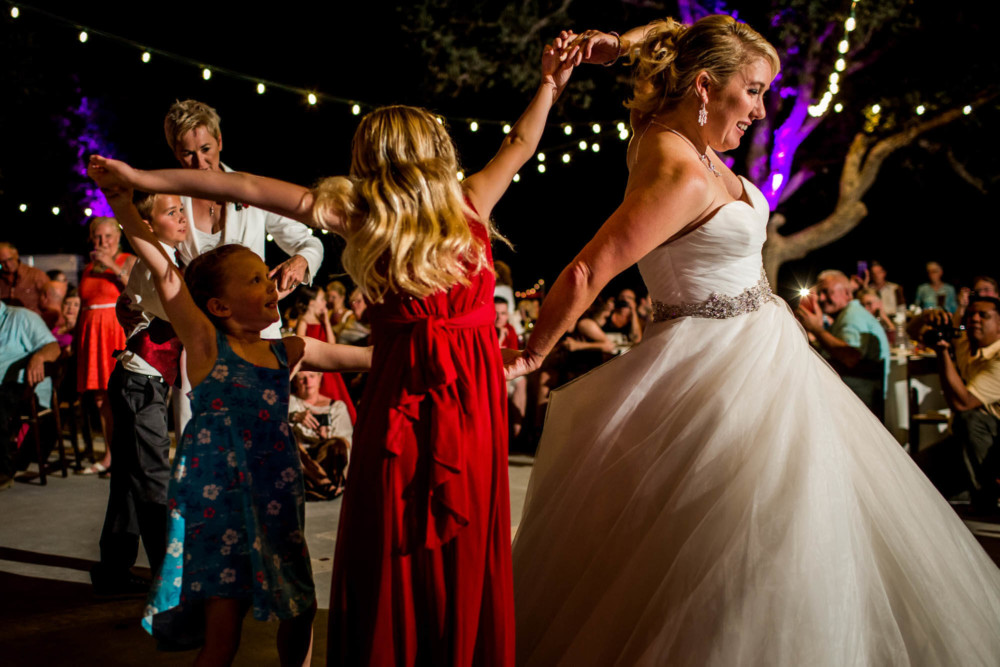 Bride dances with her daughter at a wedding reception