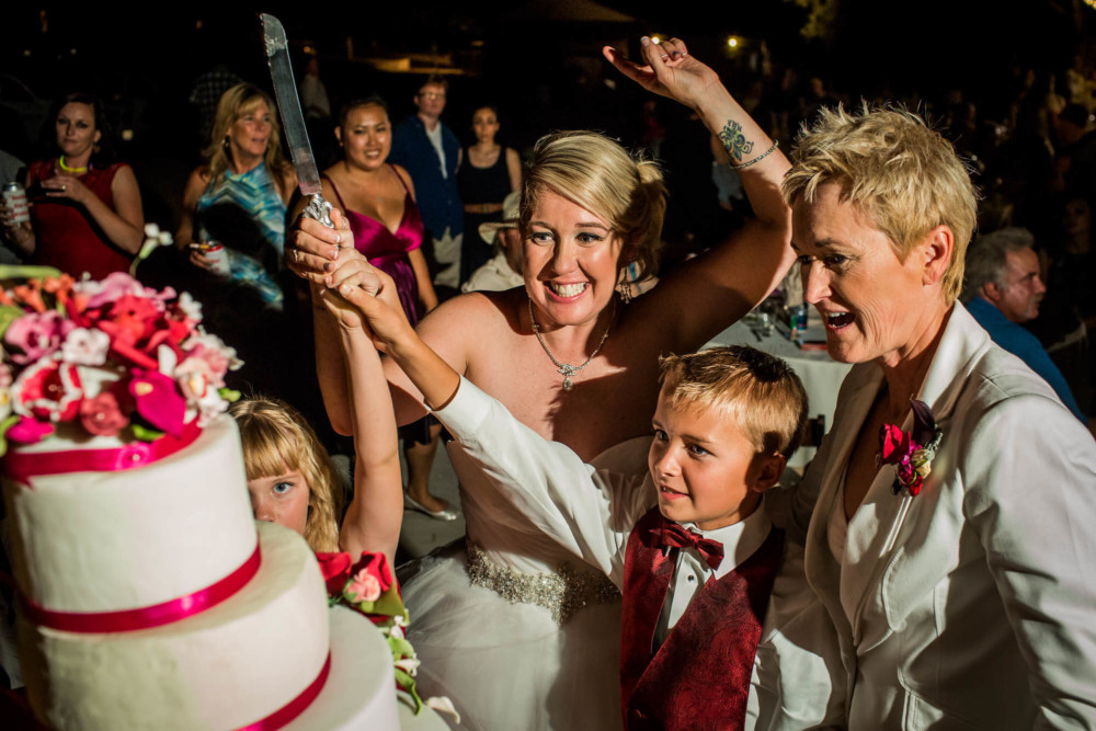 Crazy cake cutting with two brides and two children