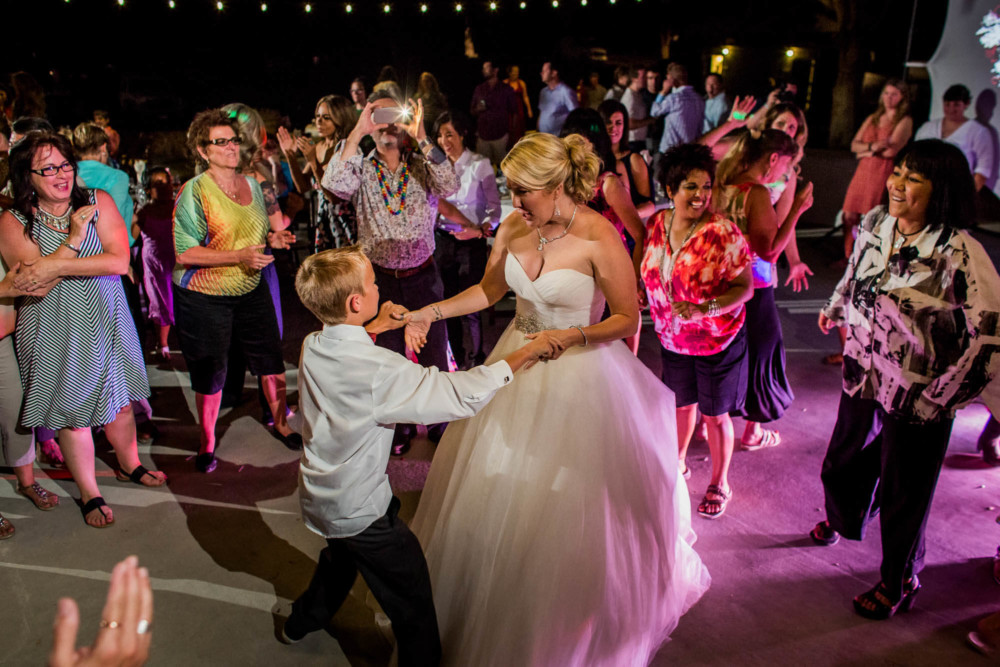 Bride dances with her sone during the wedding reception