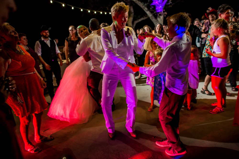 Bride dances with her new step son during the wedding reception