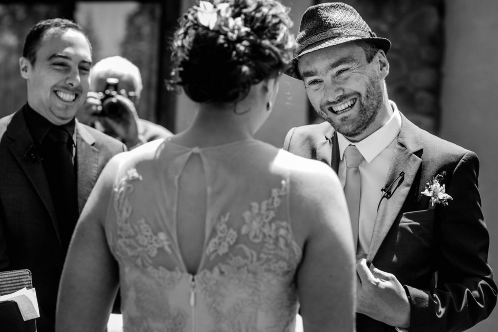 Groom smiles at his bride during the wedding ceremony