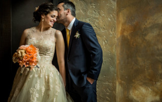 Groom kisses the brides forehead in a portrait