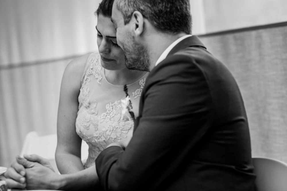 Bride and groom steal a tender moment during their reception