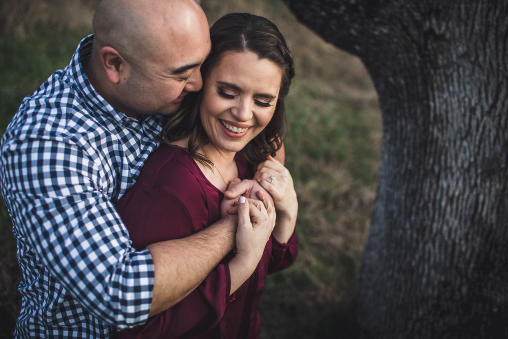 A couple snuggles during an engagement session portrait