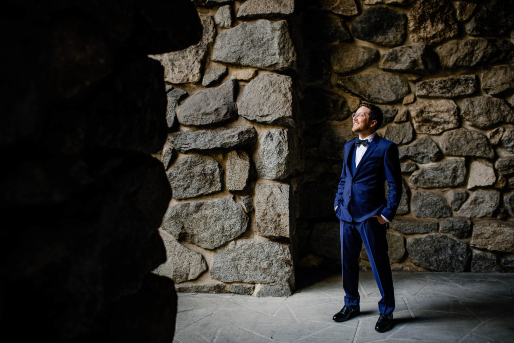 Portrait of a groom looking up at the cliffs of Yosemite
