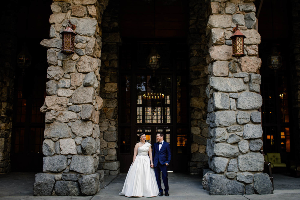 Portrait of the bride and groom holding hands at the Majestic Yosemite Hotel
