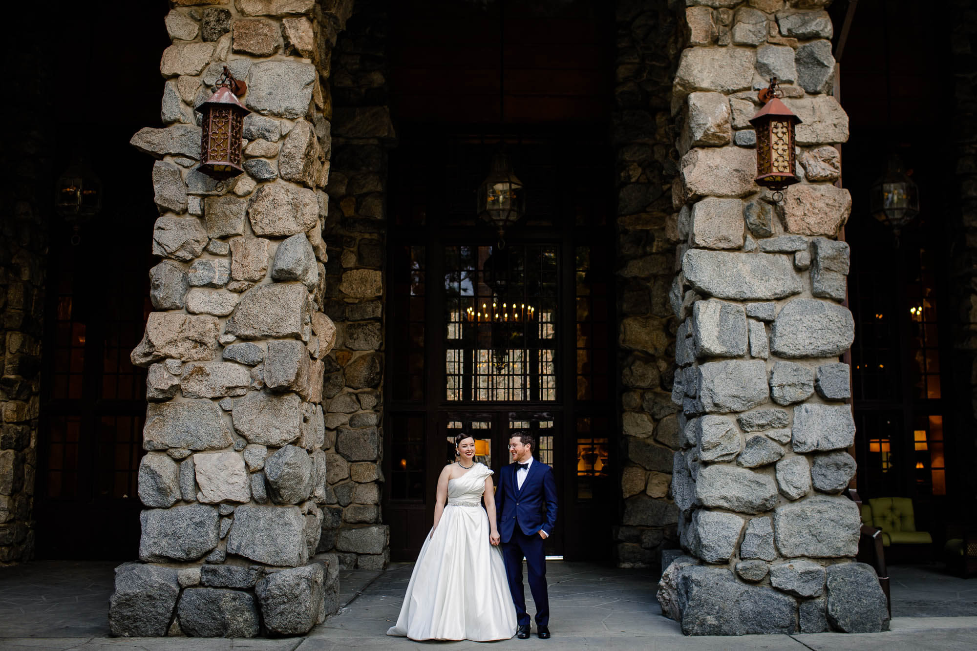 Portrait of the bride and groom holding hands at the Majestic Yosemite Hotel