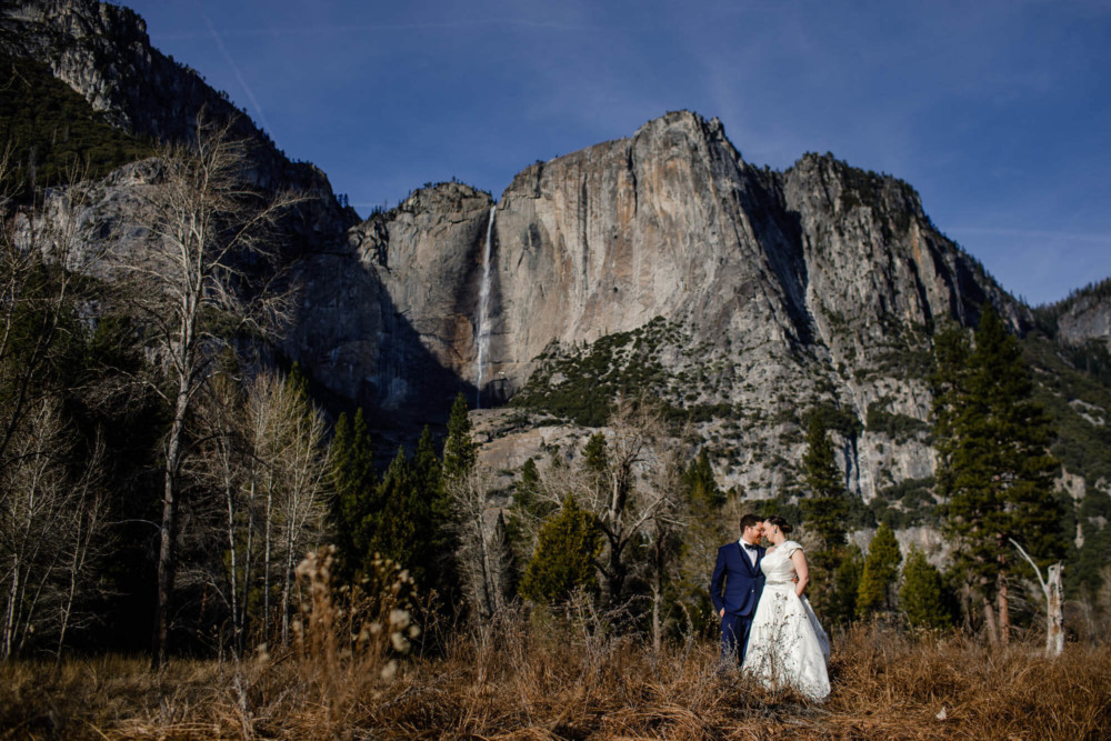 Portrait of a bride and groom in front of Yosemite Falls