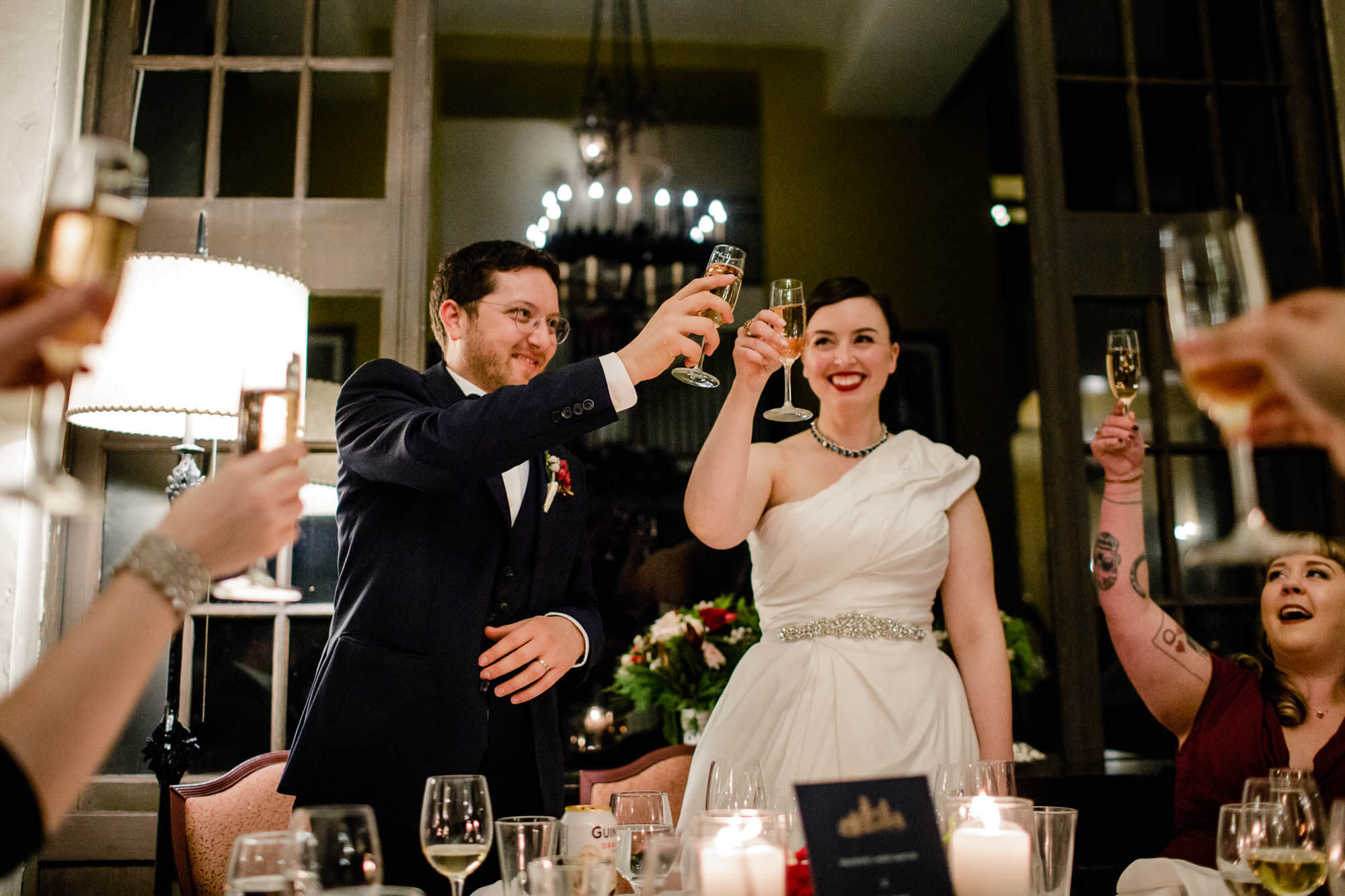 Bride and groom raise their glasses to their guests during their wedding reception