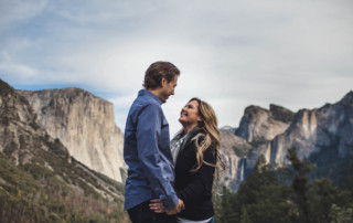Couple staring into each other's eyes in front of Yosemite valley at Tunnel View