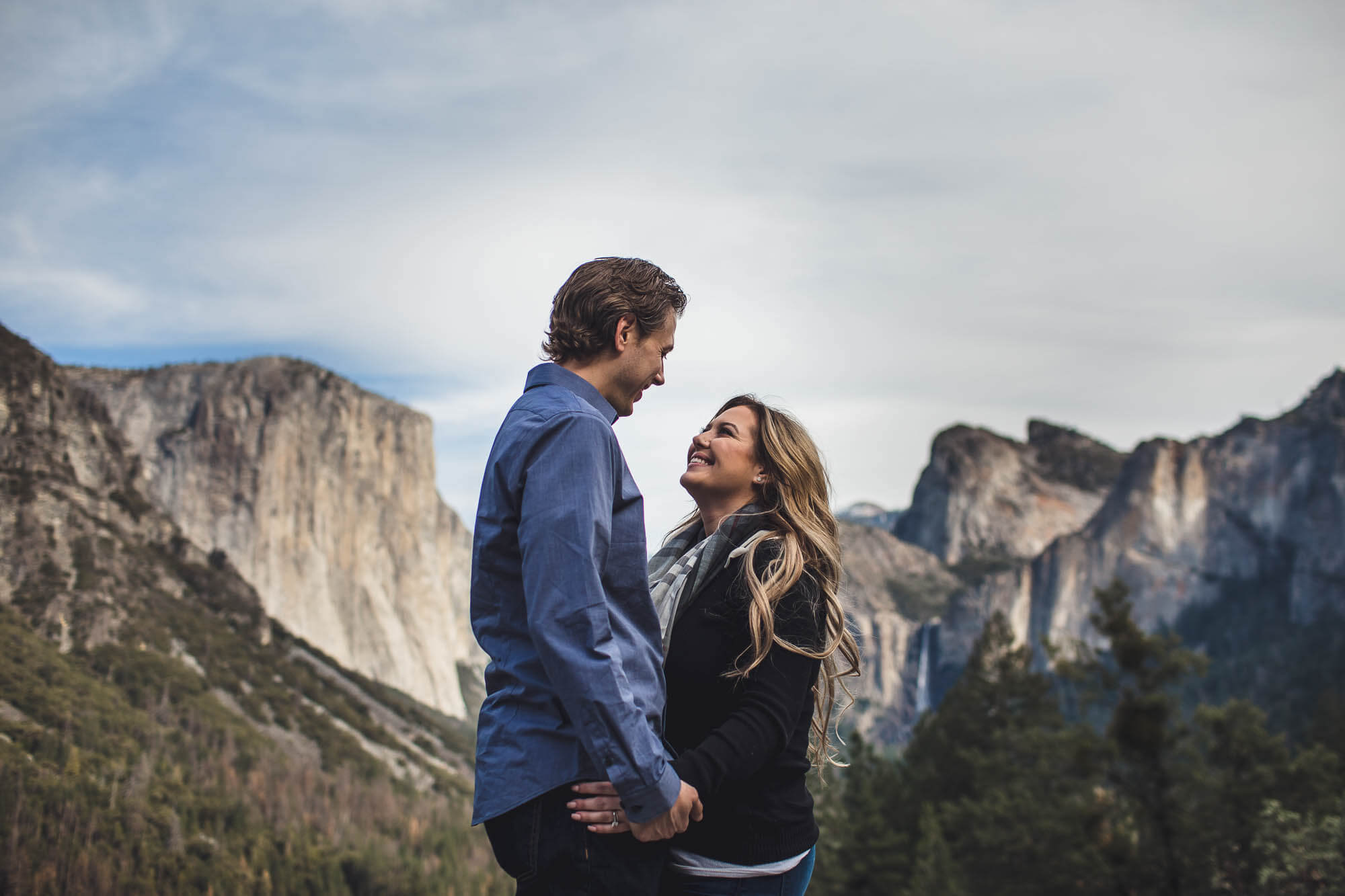 Couple staring into each other's eyes in front of Yosemite valley at Tunnel View
