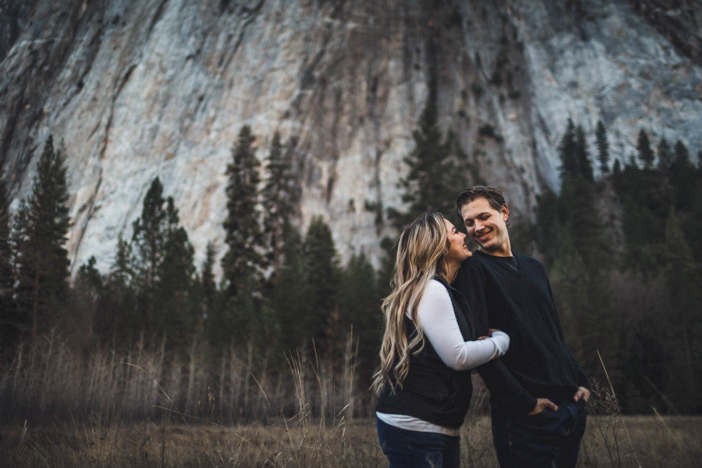 A couple shares a funny moment in El Capitan Meadow