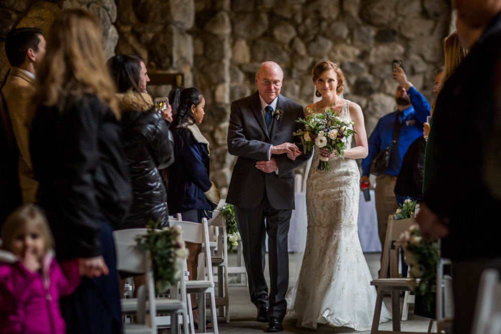Bride and her father walking down the aisle at the wedding ceremony at the Majestic Yosemite Hotel