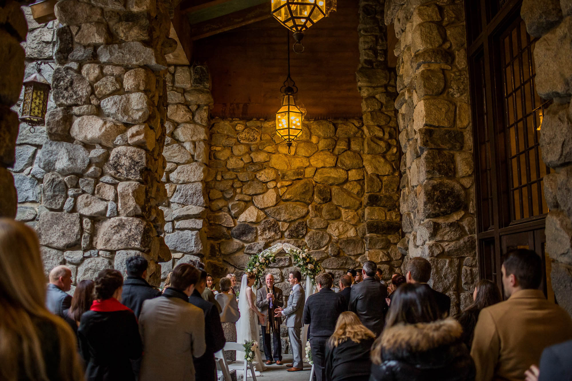 Wedding ceremony at the east portico at The Majestic Yosemite Hotel during rain