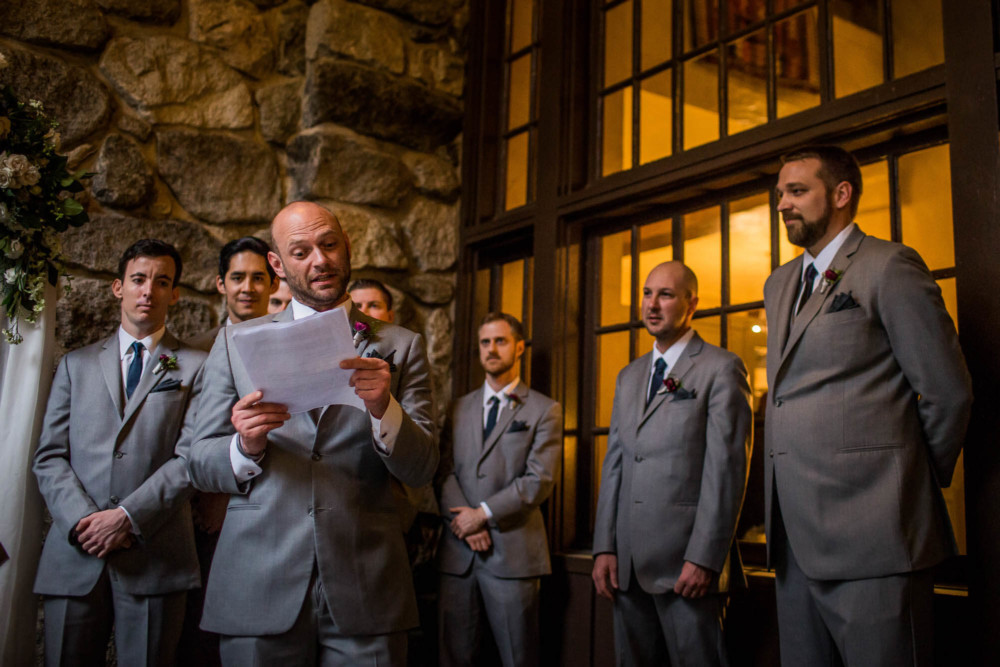 Groomsman reading during a wedding ceremony