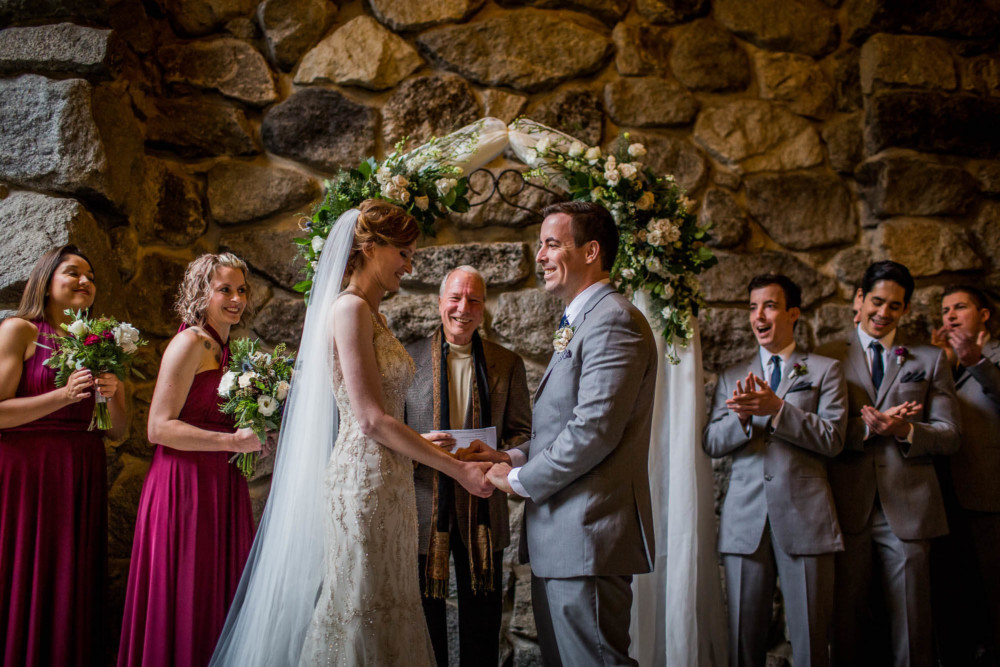 Bride and groom smile at each other during their ceremony in Yosemite