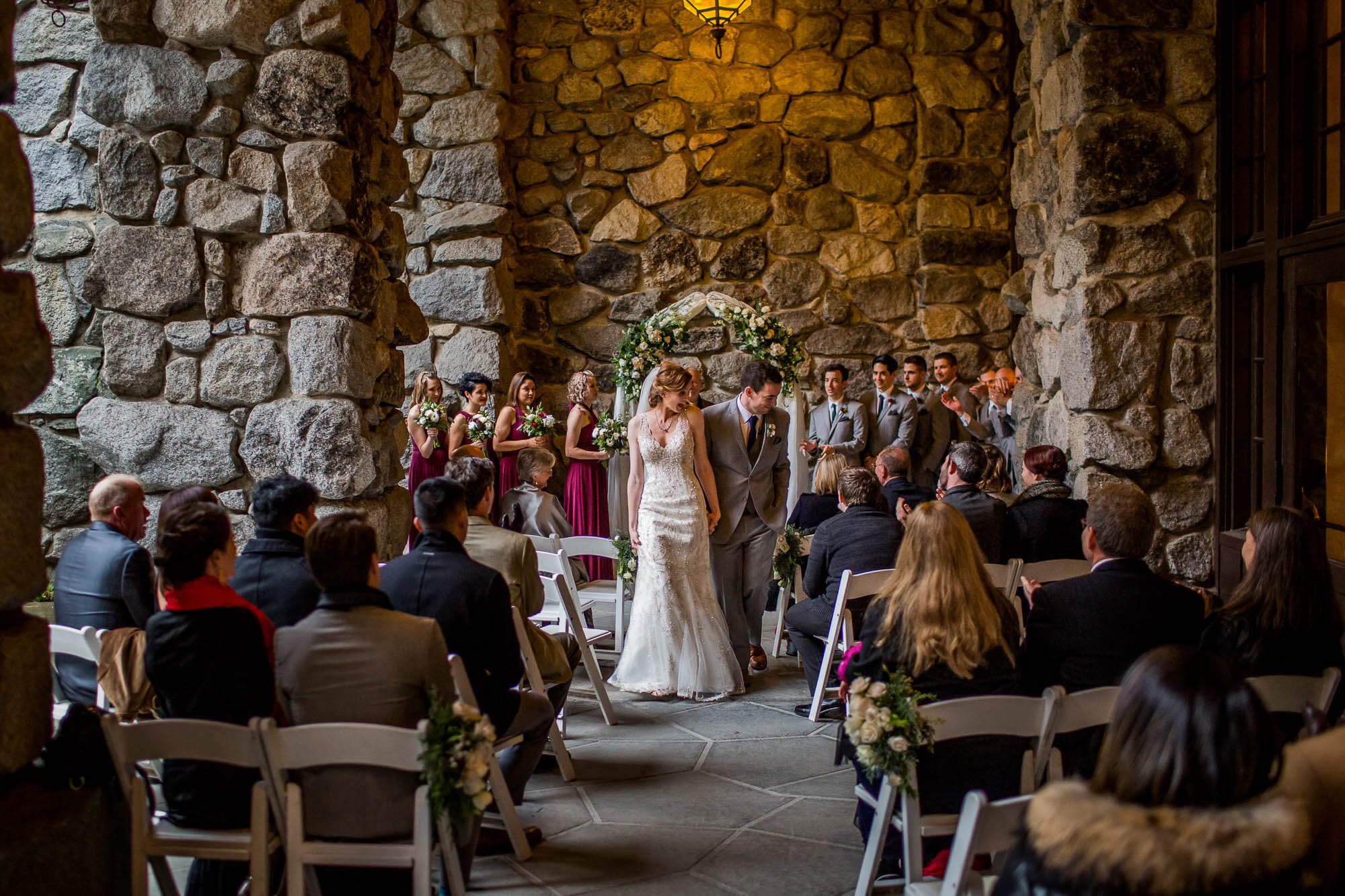 Bride and groom walk down the aisle after their wedding ceremony on the east Portico at the Majestic Yosemite Hotel