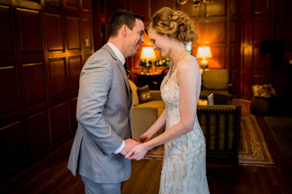 Bride and groom sharing a moment in the Library Suite at the Ahwanee hotel before their wedding