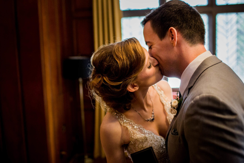 Bride and groom share a kiss in the Library Suite at the Majestic Yosemite Hotel