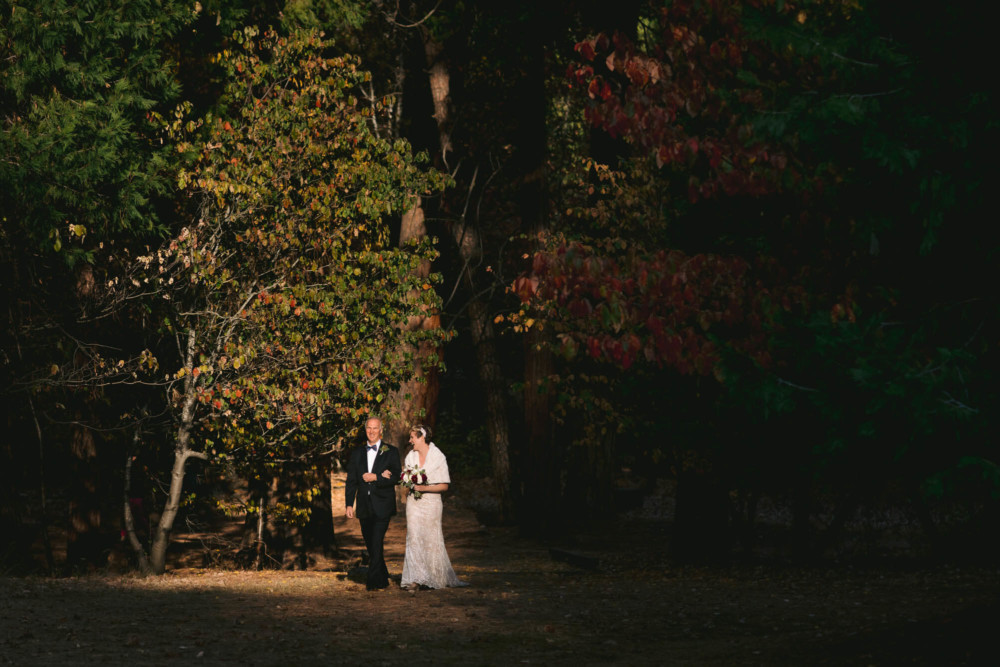 Bride and her father enter the wedding ceremony on the Majestic Yosemite wedding lawn