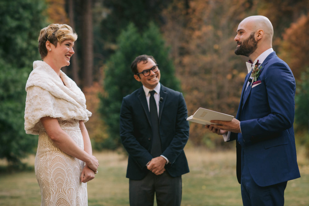 Bride and officiant react to groom reading his vows at their Majestic Yosemite wedding