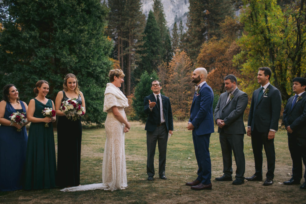 Officiant flips a coin during a wedding at the Majestic Yosemite Hotel