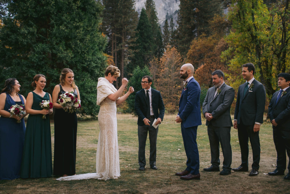 Bride pumps her fist in victory during a Yosemite wedding