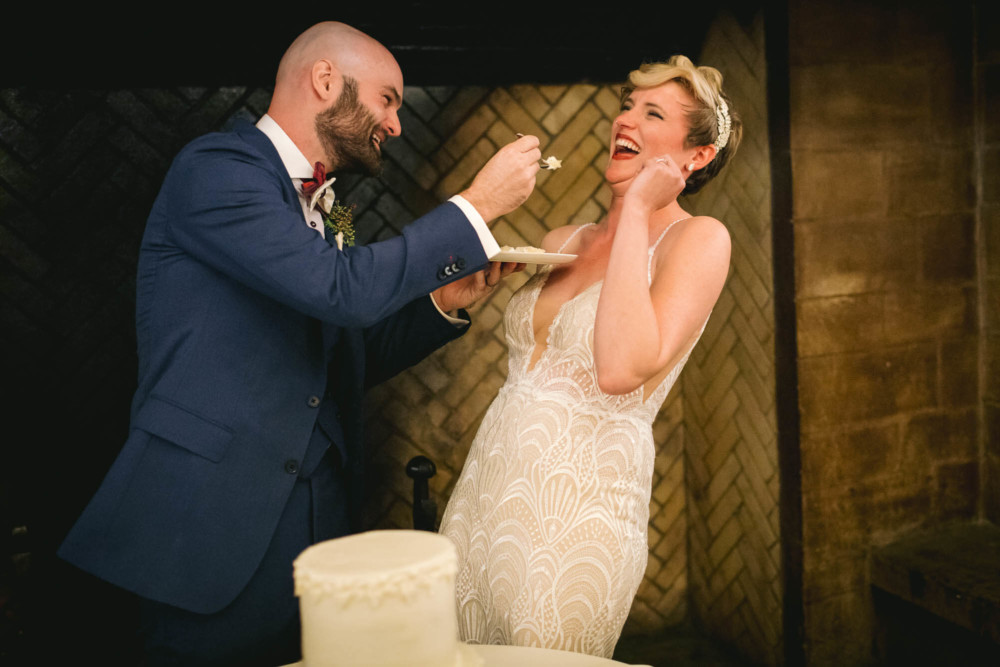 Groom feeds cake to his bride after their Yosemite wedding