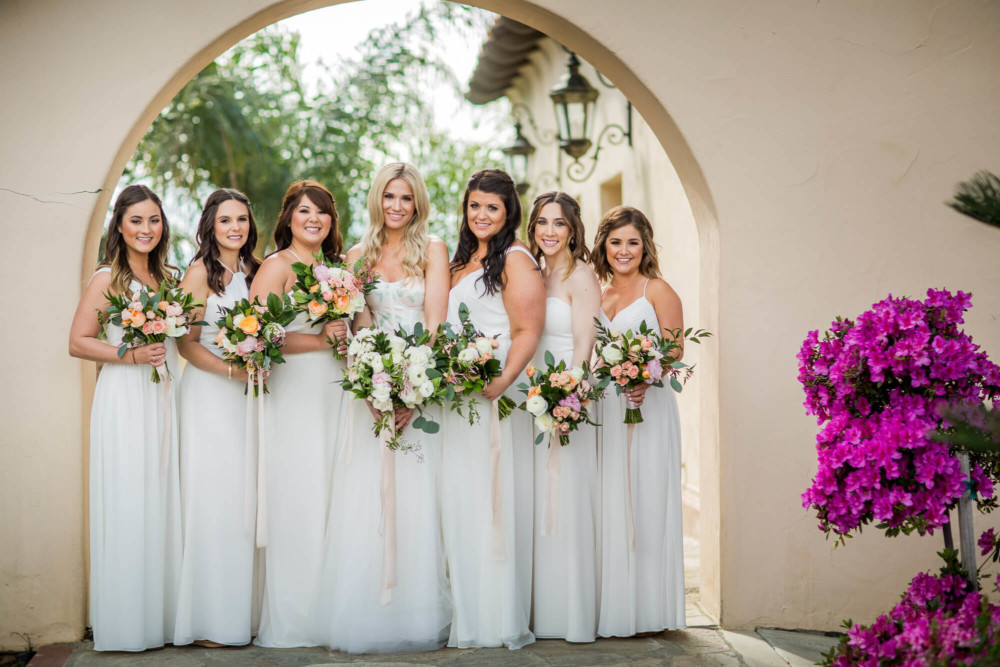 Portrait of bride and bridesmaids under an arch at Copper River Country club