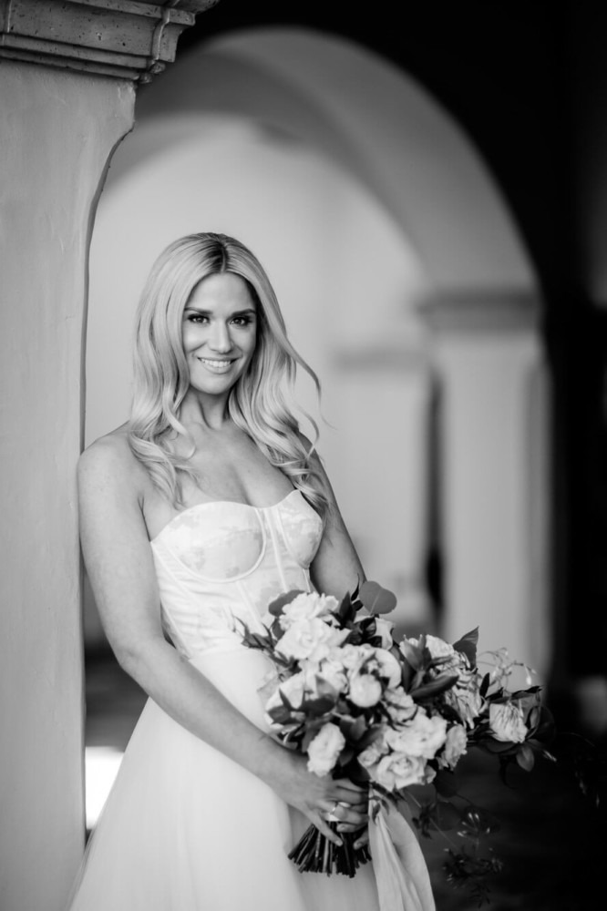 black and white portrait of a bride under an arch