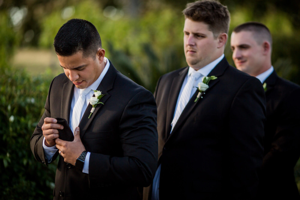 Best man pulls the wedding rings from his pocket